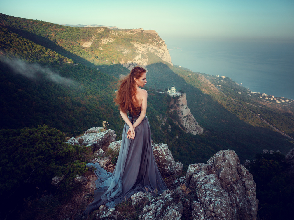 Summer Outdoors Portrait of Beautiful Furious Scandinavian Warrior Ginger Woman in Grey Dress with Metal Chain Mail.